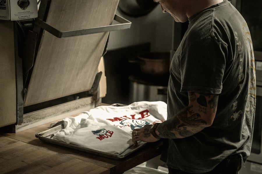 A printed t-shirt laid on a heat press ready for pressing
