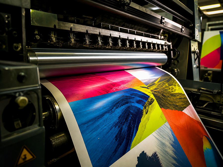 A printing press running large-format colour artwork