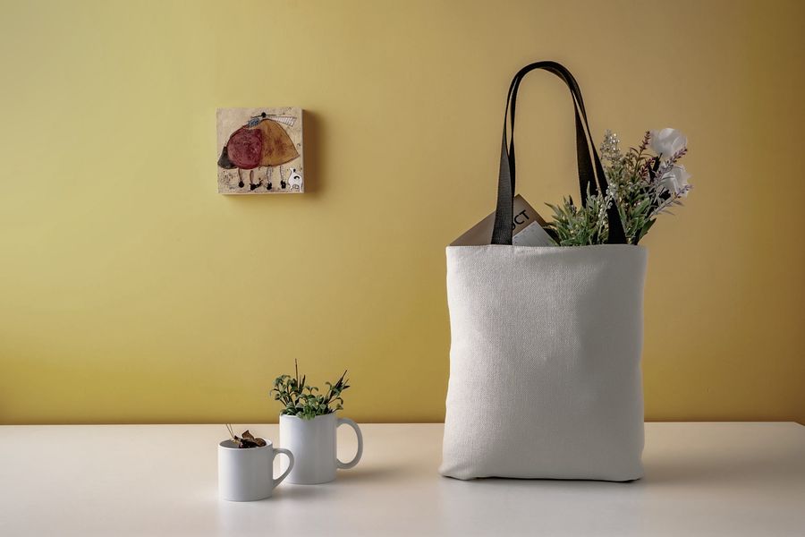 Plain white mugs and a canvas tote bag ready for branding
